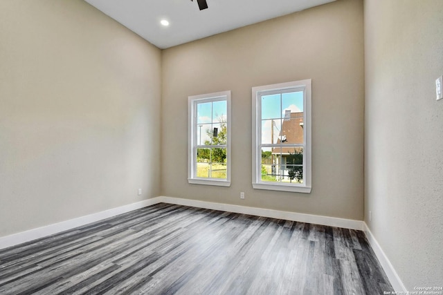 spare room featuring dark wood-style flooring, baseboards, ceiling fan, and recessed lighting