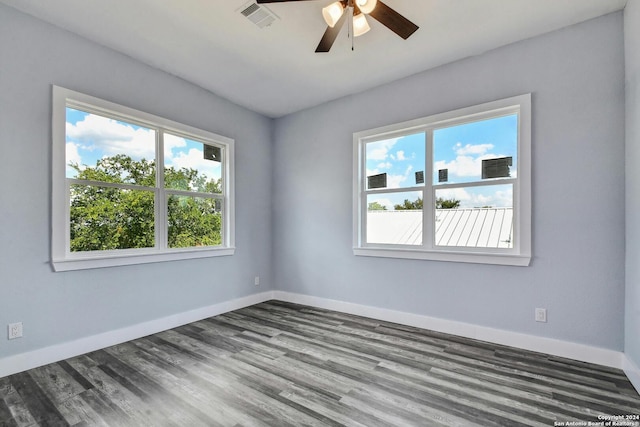 spare room featuring ceiling fan, wood finished floors, and baseboards