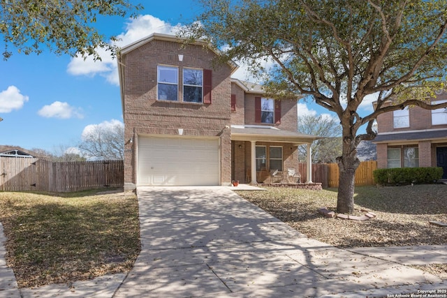traditional home with brick siding, an attached garage, fence, a porch, and driveway