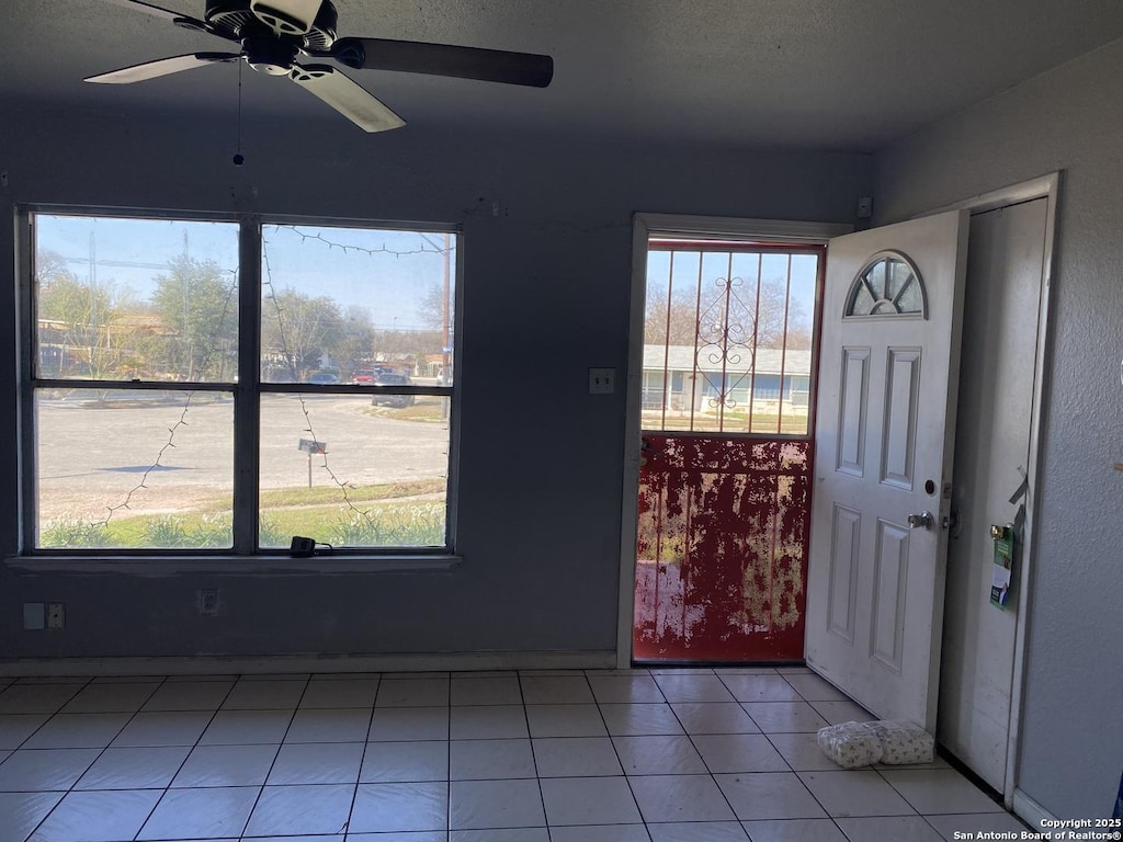 entryway with tile patterned flooring and ceiling fan