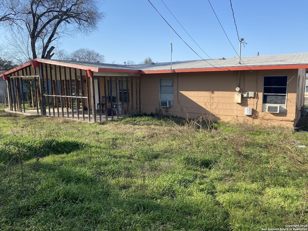 rear view of house with cooling unit and a patio area