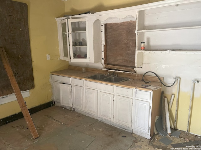108 Ripford, San Antonio, TX 78204 - kitchen featuring light countertops, glass insert cabinets, and a sink