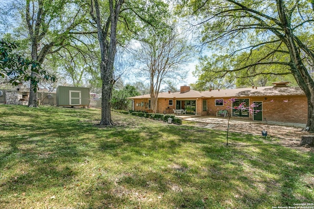 view of yard with an outdoor structure, a shed, and a patio