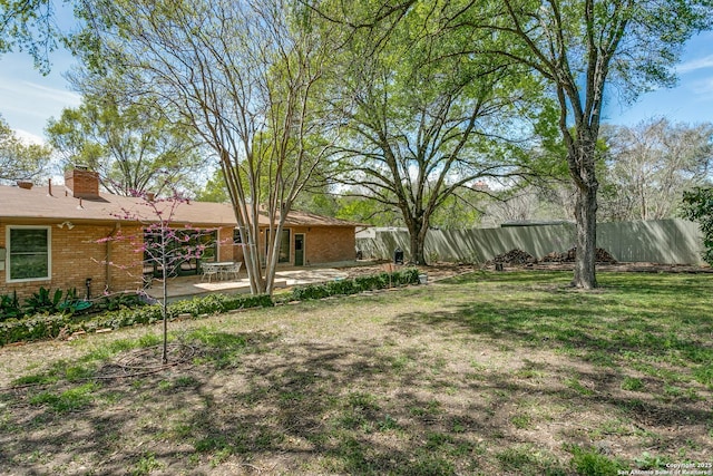 view of yard with a patio and fence