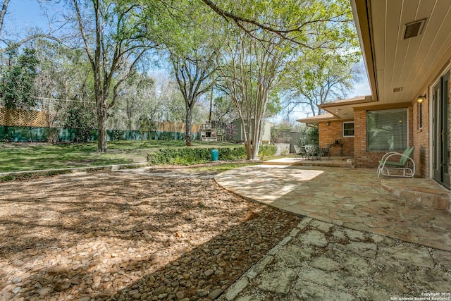 view of yard with a patio and fence