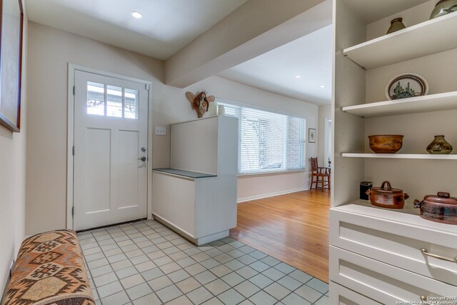 entrance foyer featuring light tile patterned floors, baseboards, and recessed lighting