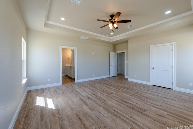 301 Honeysuckle Ln, Vernia, TX 78121 - unfurnished bedroom with visible vents, baseboards, a raised ceiling, and light wood-style floors