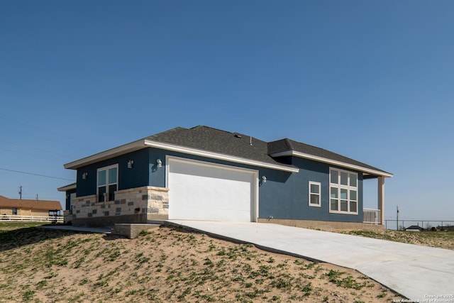 301 Honeysuckle Ln, Vernia, TX 78121 - view of front of house featuring stucco siding, driveway, stone siding, roof with shingles, and an attached garage