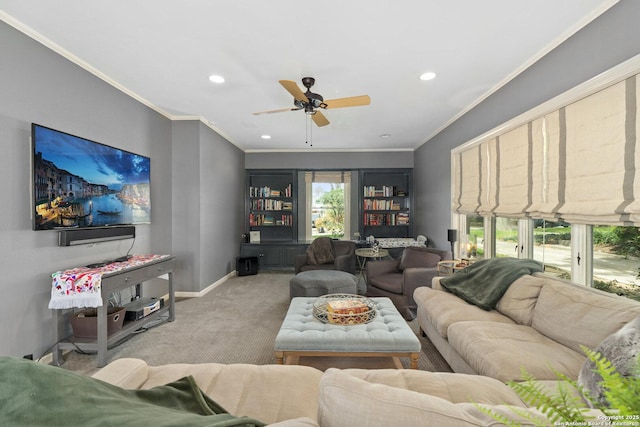 living area featuring baseboards, carpet floors, ornamental molding, and a ceiling fan