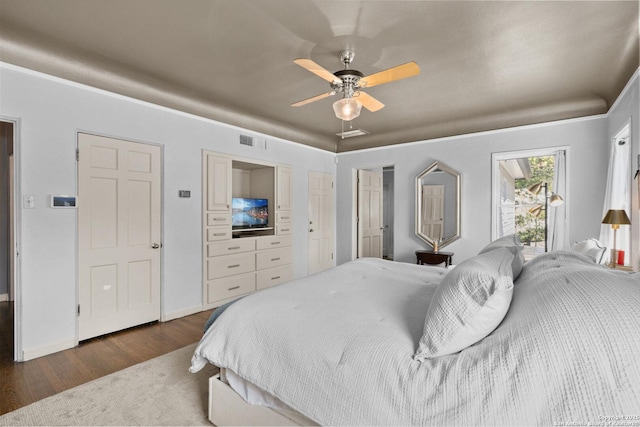 bedroom with baseboards, dark wood-style floors, visible vents, and ceiling fan