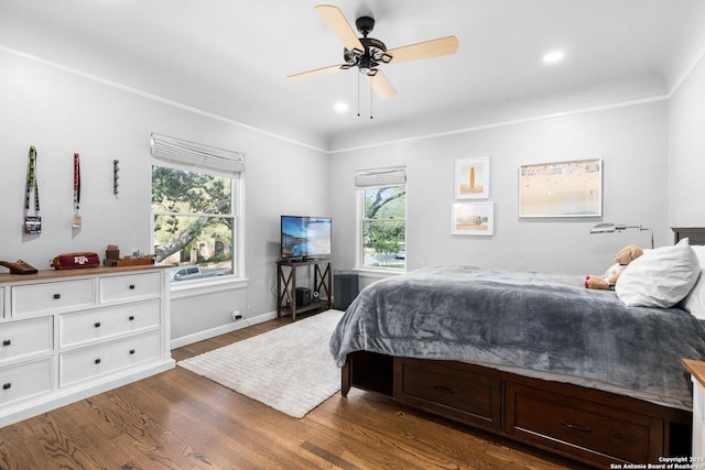 bedroom featuring crown molding, recessed lighting, wood finished floors, and baseboards