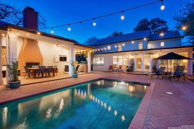 pool with a patio area and french doors