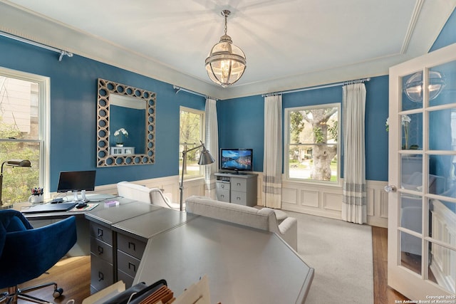 home office with an inviting chandelier, a decorative wall, carpet floors, and wainscoting