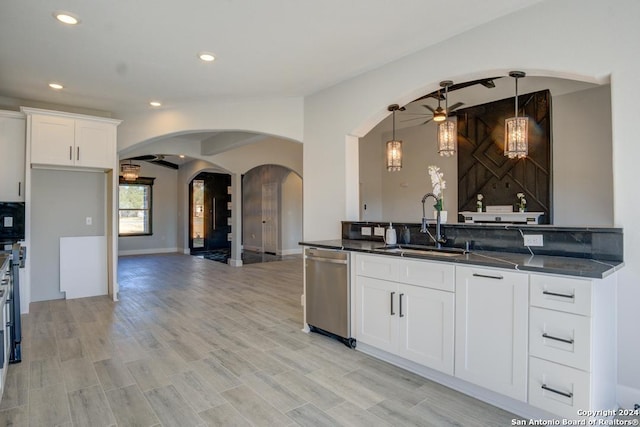 116 Hidden Ranch Ct, Floresville, TX 78114 - kitchen featuring arched walkways, stainless steel dishwasher, dark countertops, a sink, and ceiling fan