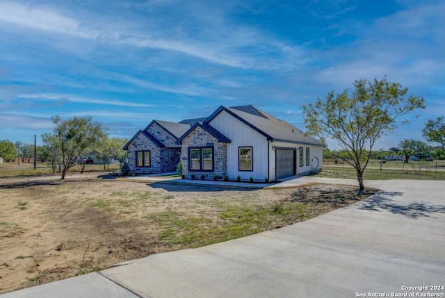 116 Hidden Ranch Ct, Floresville, TX 78114 - view of front of home featuring stone siding, an attached garage, and driveway