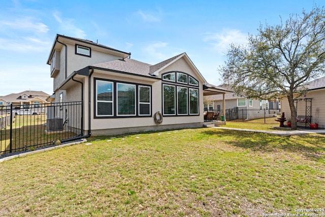 back of property featuring stucco siding, a lawn, a patio area, and fence