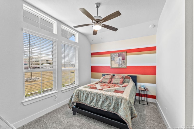 carpeted bedroom featuring baseboards, lofted ceiling, and a ceiling fan
