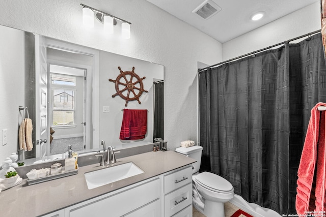 full bathroom with visible vents, curtained shower, toilet, and vanity