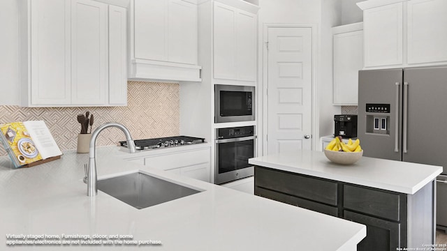 4971 Park Mnr, Schertz, TX 78124 - kitchen with stainless steel appliances, light countertops, backsplash, a sink, and white cabinets