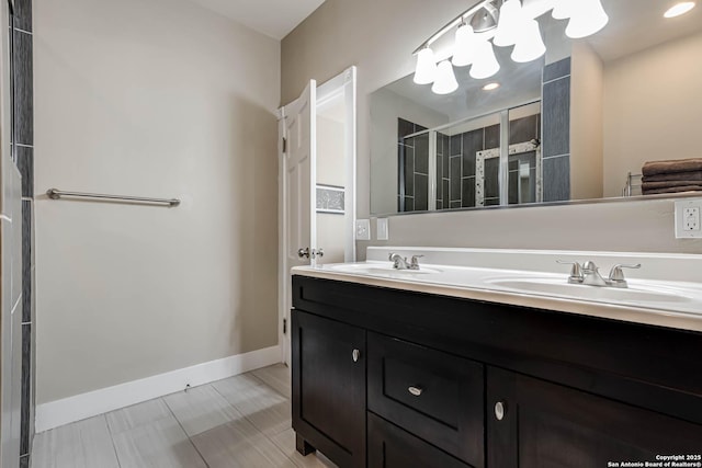 2106 W Gramercy Pl, San Antonio, TX 78201 - full bathroom featuring double vanity, baseboards, a stall shower, and a sink