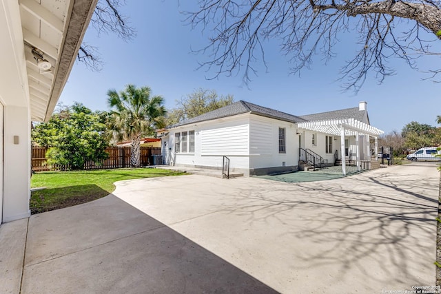 2106 W Gramercy Pl, San Antonio, TX 78201 - back of property featuring fence, roof with shingles, a lawn, a patio area, and a pergola