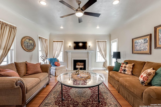 2106 W Gramercy Pl, San Antonio, TX 78201 - living area featuring a ceiling fan, baseboards, a fireplace, recessed lighting, and light wood-style floors