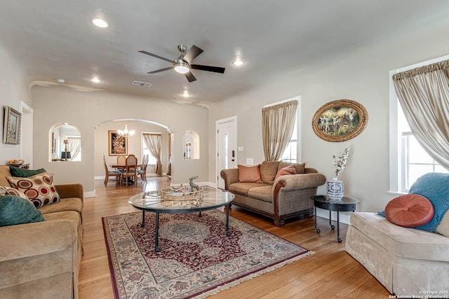 2106 W Gramercy Pl, San Antonio, TX 78201 - living room featuring light wood-style floors, arched walkways, and a wealth of natural light