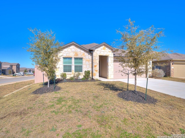 single story home featuring concrete driveway, a garage, stone siding, and a front lawn