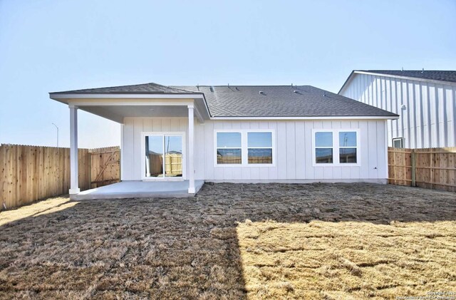 1514 Saddleback, New Braunfels, TX 78130 - back of property featuring a shingled roof, board and batten siding, a patio, and a fenced backyard