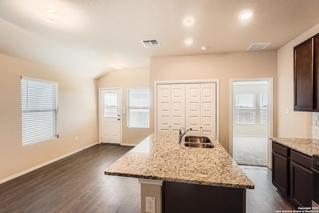 2066 Chelsea, New Braunfels, TX 78130 - kitchen with light stone counters, visible vents, dark brown cabinets, and a sink