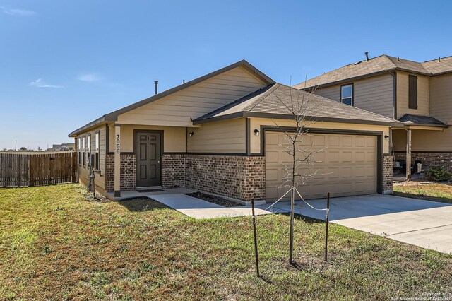 2066 Chelsea, New Braunfels, TX 78130 - view of front of house featuring brick siding, concrete driveway, fence, and a garage