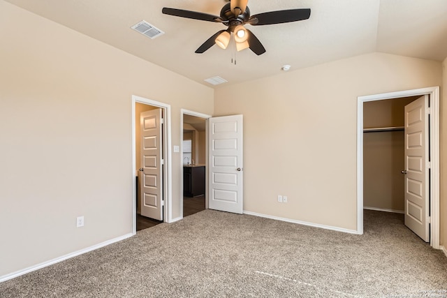 2066 Chelsea, New Braunfels, TX 78130 - unfurnished bedroom featuring carpet, visible vents, baseboards, vaulted ceiling, and a walk in closet
