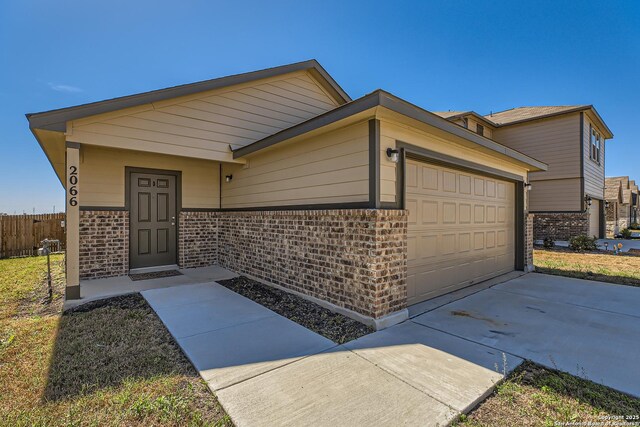 2066 Chelsea, New Braunfels, TX 78130 - view of front of home with brick siding, an attached garage, driveway, and fence