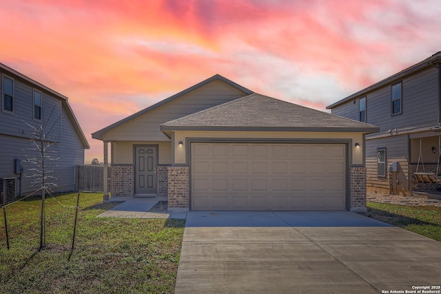 2066 Chelsea, New Braunfels, TX 78130 - view of front of house featuring brick siding, a shingled roof, a front yard, a garage, and driveway