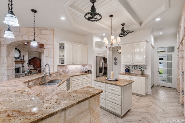 1626 Cordillera Trce, Boerne, TX 78006 - kitchen with arched walkways, a sink, stainless steel fridge with ice dispenser, open shelves, and light stone countertops