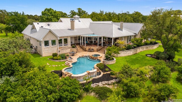 1626 Cordillera Trce, Boerne, TX 78006 - back of property with a yard, stone siding, and metal roof