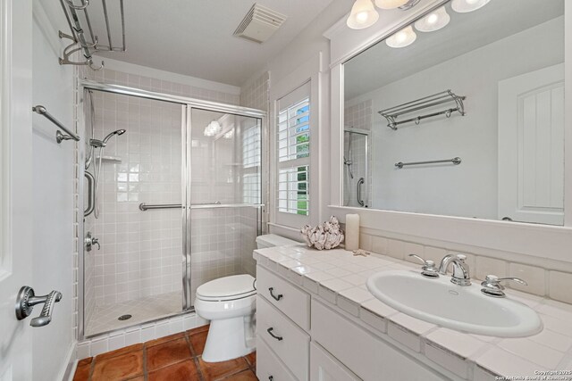 1626 Cordillera Trce, Boerne, TX 78006 - full bathroom featuring tile patterned floors, visible vents, toilet, vanity, and a stall shower