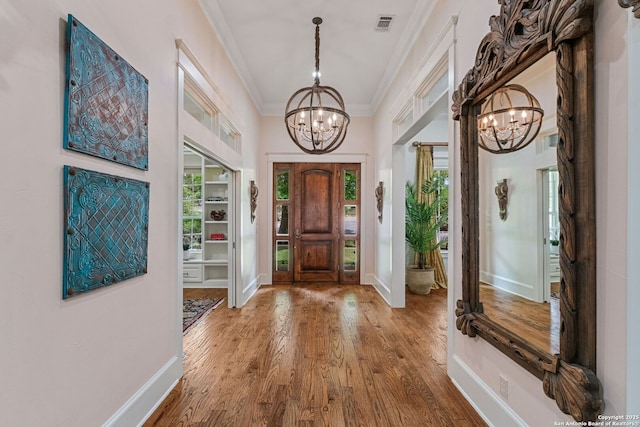 1626 Cordillera Trce, Boerne, TX 78006 - entrance foyer featuring a chandelier, wood finished floors, visible vents, and crown molding