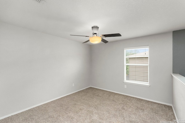 unfurnished room with baseboards, a ceiling fan, and carpet floors