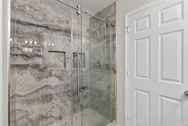 bathroom featuring a marble finish shower