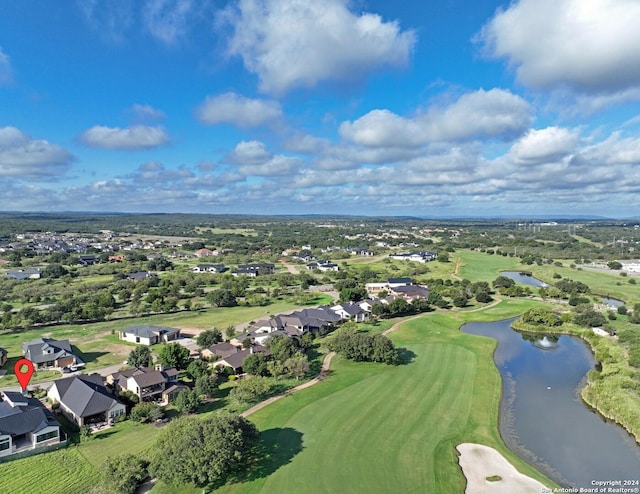 aerial view featuring golf course view, a water view, and a residential view