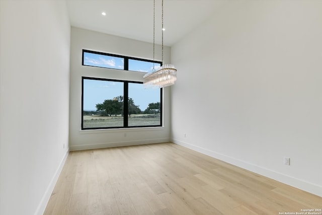 130 Azalea Loop, Horseshoe Bay, TX 78657 - unfurnished room with an inviting chandelier, recessed lighting, wood finished floors, and baseboards