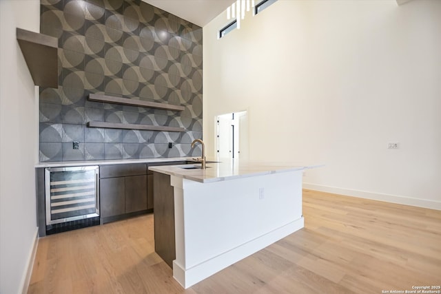 130 Azalea Loop, Horseshoe Bay, TX 78657 - kitchen with backsplash, wine cooler, light wood-type flooring, light countertops, and modern cabinets