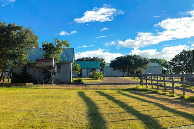 view of yard featuring an outdoor structure and fence
