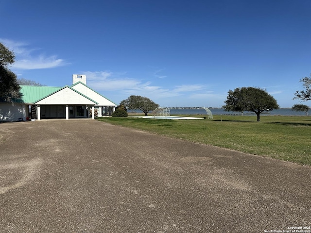 exterior space featuring a carport, driveway, and a water view