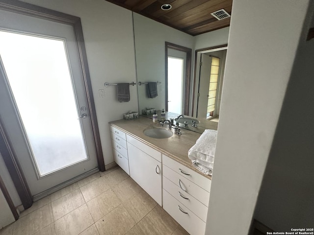 bathroom with vanity, wooden ceiling, visible vents, and a wealth of natural light