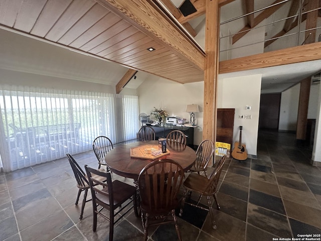 dining space featuring beamed ceiling