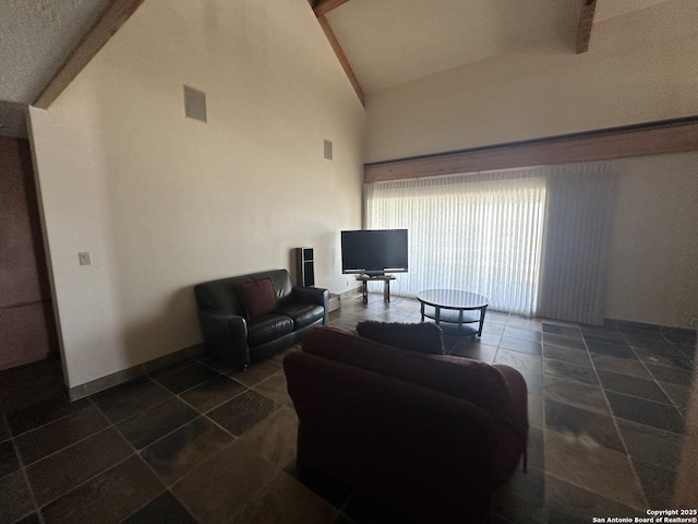 living room with dark tile patterned flooring, baseboards, visible vents, and high vaulted ceiling