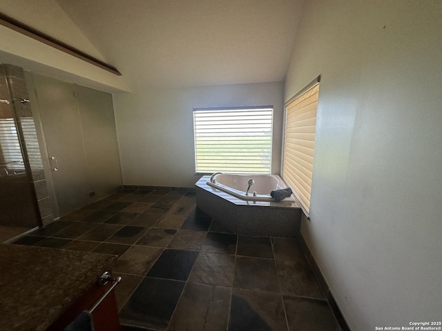 full bathroom with a shower with door, baseboards, lofted ceiling, and a bath