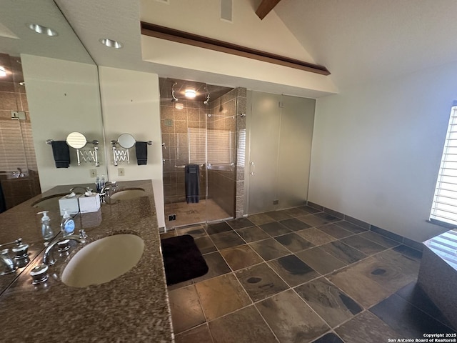 bathroom featuring a sink, lofted ceiling, a stall shower, and double vanity